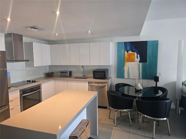 1600 NE 1st Ave Unit 3017, Miami, FL 33132 - kitchen with black appliances, wall chimney range hood, light countertops, backsplash, and recessed lighting