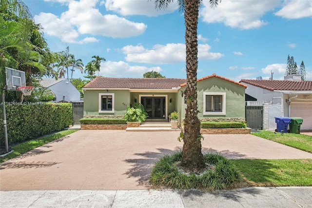 441 SW 27th Rd, Miami, FL 33129 - mediterranean / spanish house with a gate, stucco siding, a tile roof, and french doors