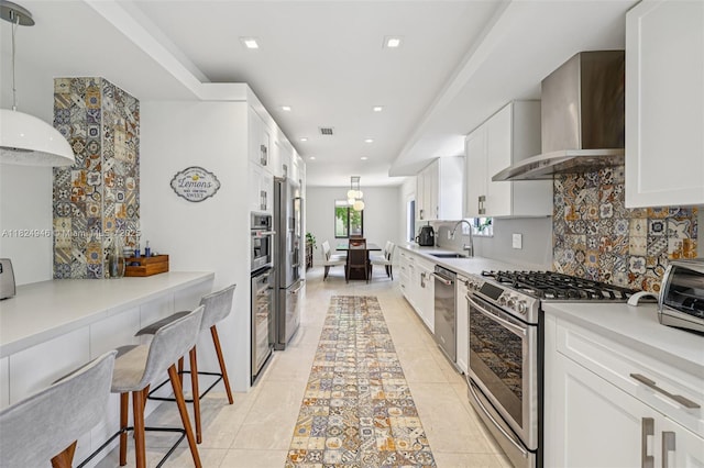 441 SW 27th Rd, Miami, FL 33129 - kitchen with appliances with stainless steel finishes, wall chimney exhaust hood, backsplash, white cabinetry, and recessed lighting