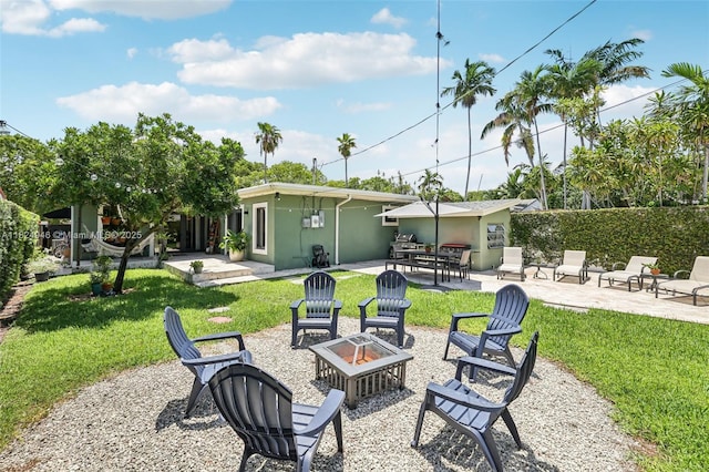 441 SW 27th Rd, Miami, FL 33129 - rear view of property with an outdoor fire pit, a patio area, stucco siding, and a lawn