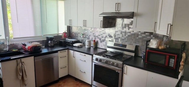 1607 Moffett St, Hollywood, FL 33020 - kitchen with stainless steel appliances, under cabinet range hood, backsplash, and dark countertops