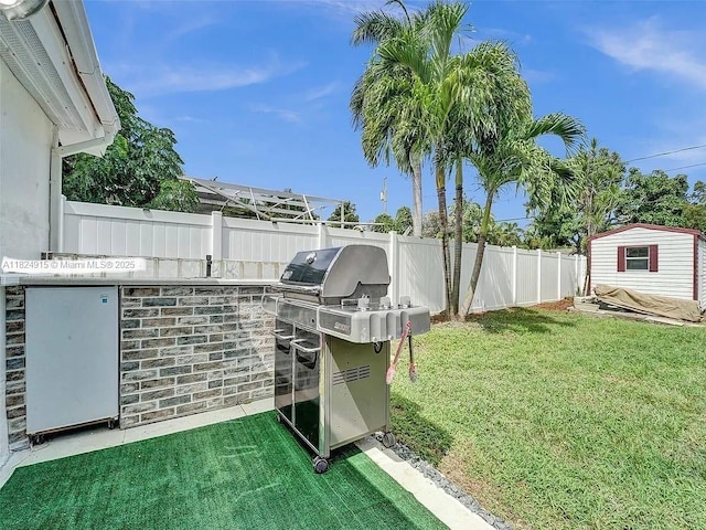 1607 Moffett St, Hollywood, FL 33020 - fenced backyard with a storage unit and exterior kitchen