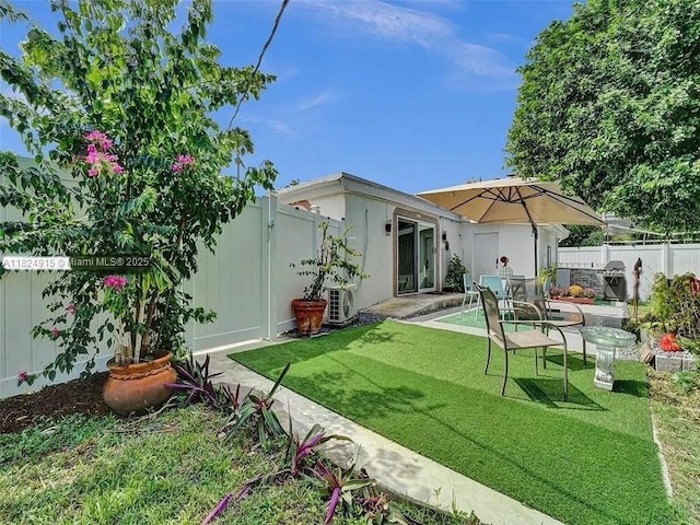 1607 Moffett St, Hollywood, FL 33020 - rear view of house featuring a fenced backyard and a patio area