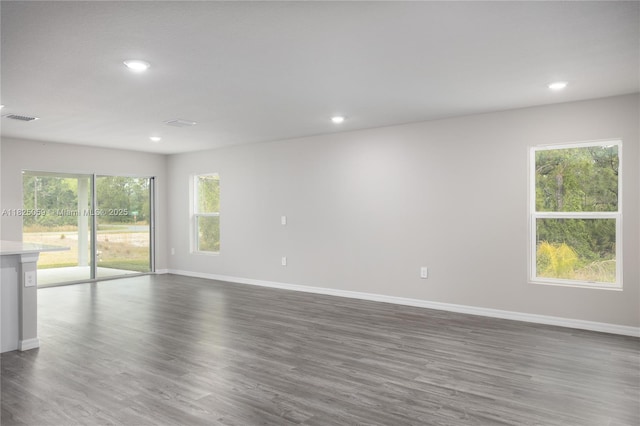 899 Brickell St SE, Palm Bay, FL 32909 - unfurnished room featuring recessed lighting and dark wood-type flooring