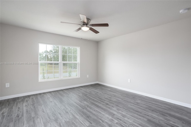 899 Brickell St SE, Palm Bay, FL 32909 - empty room featuring dark wood-type flooring, a ceiling fan, and a smoke detector