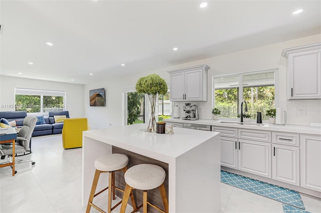 17460 SW 85th Ave, Palmetto Bay, FL 33157 - kitchen featuring a breakfast bar area, recessed lighting, light countertops, a kitchen island, and light tile patterned flooring
