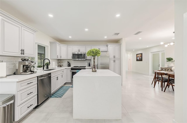 17460 SW 85th Ave, Palmetto Bay, FL 33157 - kitchen featuring stainless steel appliances, a center island, recessed lighting, light countertops, and white cabinetry