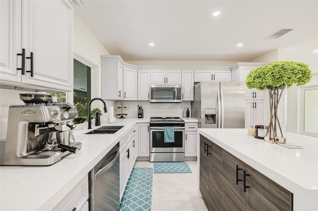 17460 SW 85th Ave, Palmetto Bay, FL 33157 - kitchen with stainless steel appliances, light countertops, white cabinetry, recessed lighting, and light tile patterned floors