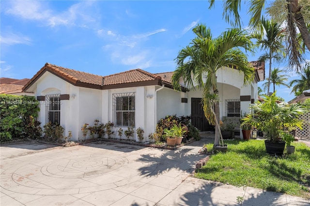 12350 NW 7th Trl, Miami, FL 33182 - mediterranean / spanish house with a tiled roof, stucco siding, and a patio area