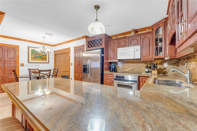 12350 NW 7th Trl, Miami, FL 33182 - kitchen featuring appliances with stainless steel finishes, glass insert cabinets, a chandelier, a textured ceiling, and crown molding