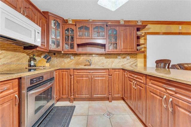 12350 NW 7th Trl, Miami, FL 33182 - kitchen featuring white microwave, stainless steel oven, open shelves, light stone counters, and backsplash