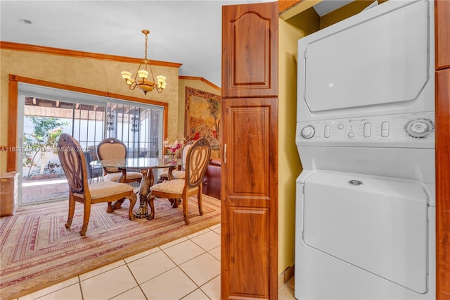 12350 NW 7th Trl, Miami, FL 33182 - washroom featuring stacked washing machine and dryer, a chandelier, crown molding, and light tile patterned floors