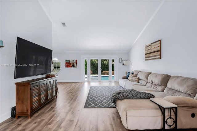 15904 W Wind Cir, Sunrise, FL 33326 - living area featuring ornamental molding, lofted ceiling, wood finished floors, and french doors