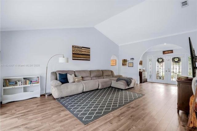 15904 W Wind Cir, Sunrise, FL 33326 - living room featuring arched walkways, wood finished floors, vaulted ceiling, and french doors