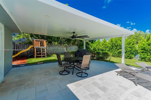 15904 W Wind Cir, Sunrise, FL 33326 - fenced backyard with a playground, a ceiling fan, a patio, and outdoor dining space
