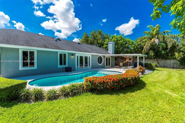 15904 W Wind Cir, Sunrise, FL 33326 - rear view of house with french doors, a chimney, a patio, stucco siding, and roof with shingles