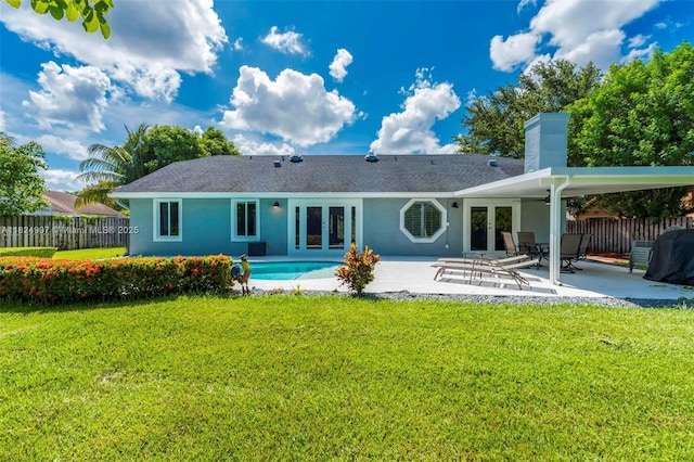 15904 W Wind Cir, Sunrise, FL 33326 - rear view of property featuring french doors, a chimney, a patio area, stucco siding, and roof with shingles