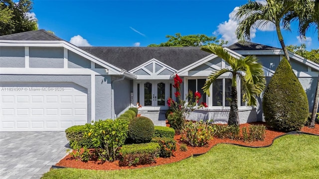 15904 W Wind Cir, Sunrise, FL 33326 - ranch-style home with french doors, stucco siding, an attached garage, decorative driveway, and a front lawn