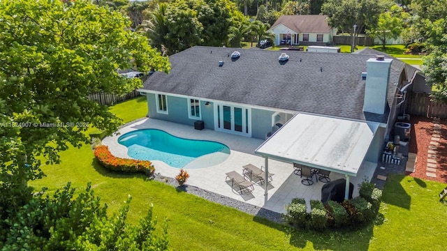 15904 W Wind Cir, Sunrise, FL 33326 - back of house featuring a patio, french doors, a chimney, and view of scattered trees