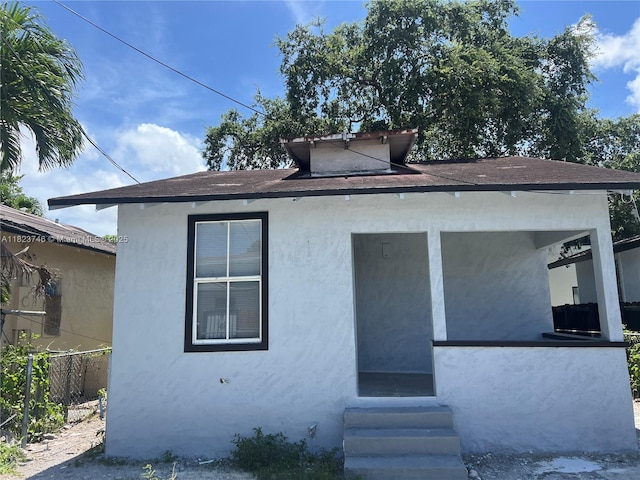 1800 SW 3rd St # B, Miami, FL 33135 - rear view of house featuring entry steps and stucco siding