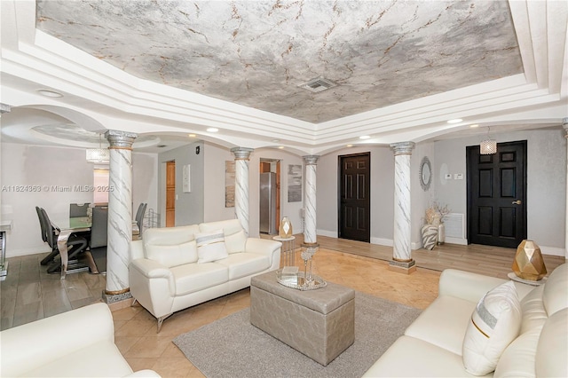 11700 Sheridan St, Pembroke Pines, FL 33026 - living room featuring decorative columns, a raised ceiling, light tile patterned floors, arched walkways, and recessed lighting