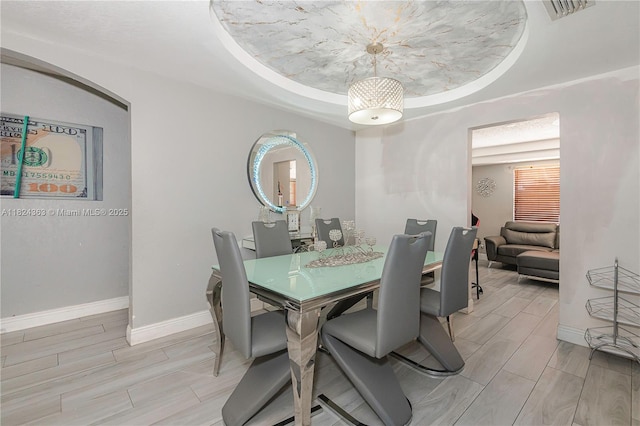11700 Sheridan St, Pembroke Pines, FL 33026 - dining area featuring healthy amount of natural light, wood finish floors, and a tray ceiling