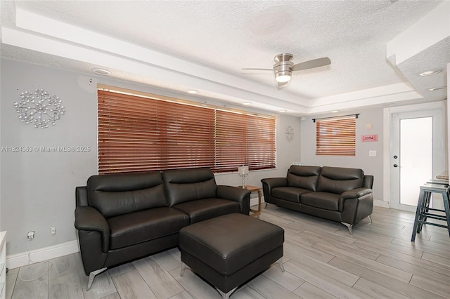 11700 Sheridan St, Pembroke Pines, FL 33026 - living area with a tray ceiling, a textured ceiling, a ceiling fan, light wood-style flooring, and recessed lighting