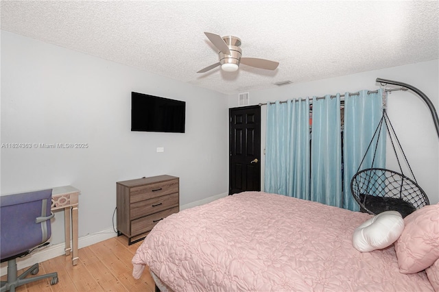 11700 Sheridan St, Pembroke Pines, FL 33026 - bedroom with light wood-style flooring, a textured ceiling, and ceiling fan