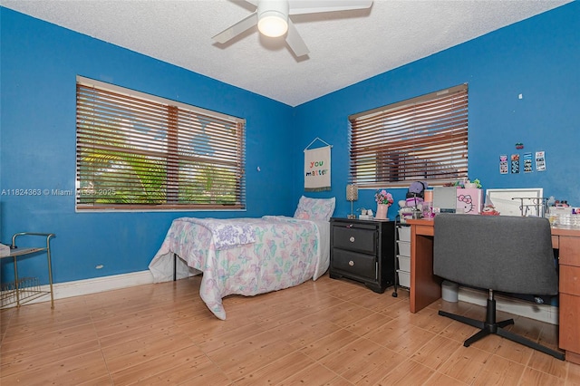 11700 Sheridan St, Pembroke Pines, FL 33026 - bedroom featuring a textured ceiling, an office area, a ceiling fan, and wood finished floors