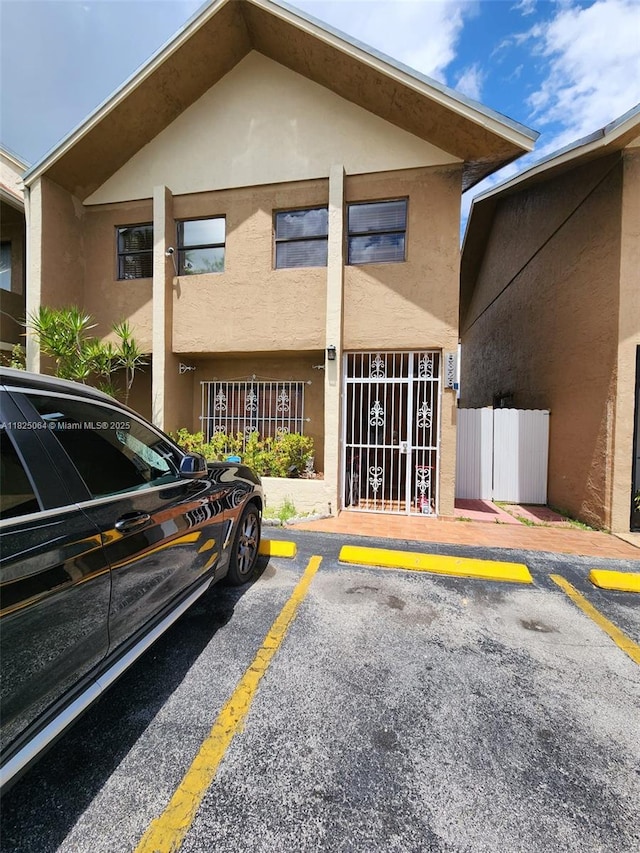 5328 W 26th Ave Unit 112, Hialeah, FL 33016 - back of house with stucco siding and uncovered parking