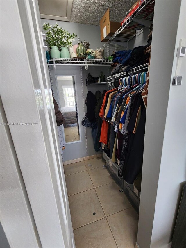 5328 W 26th Ave Unit 112, Hialeah, FL 33016 - walk in closet featuring tile patterned floors