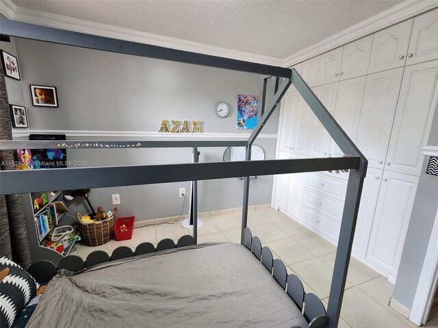5328 W 26th Ave Unit 112, Hialeah, FL 33016 - bedroom featuring crown molding, light tile patterned floors, and a textured ceiling