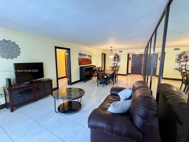 6039 Collins Ave Unit 923, Miami Beach, FL 33140 - living room featuring light tile patterned floors and baseboards