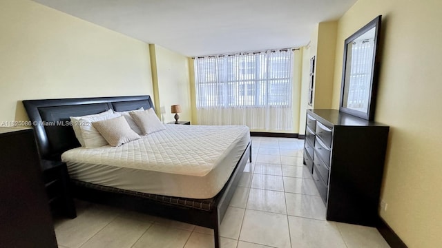 6039 Collins Ave Unit 923, Miami Beach, FL 33140 - bedroom featuring light tile patterned flooring and baseboards