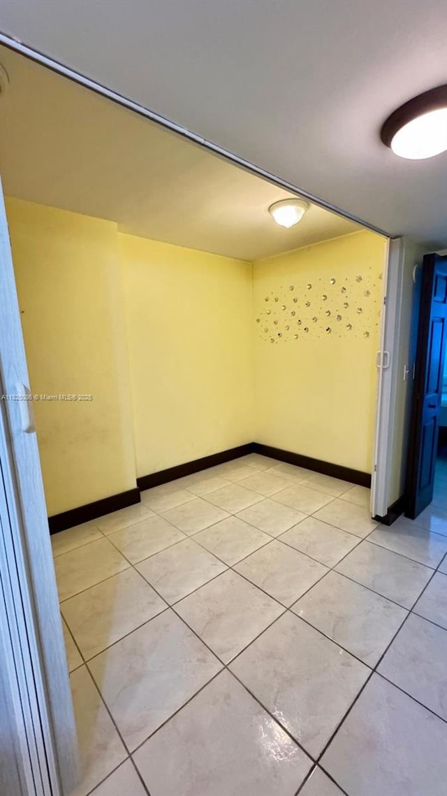 6039 Collins Ave Unit 923, Miami Beach, FL 33140 - unfurnished room featuring light tile patterned floors and baseboards