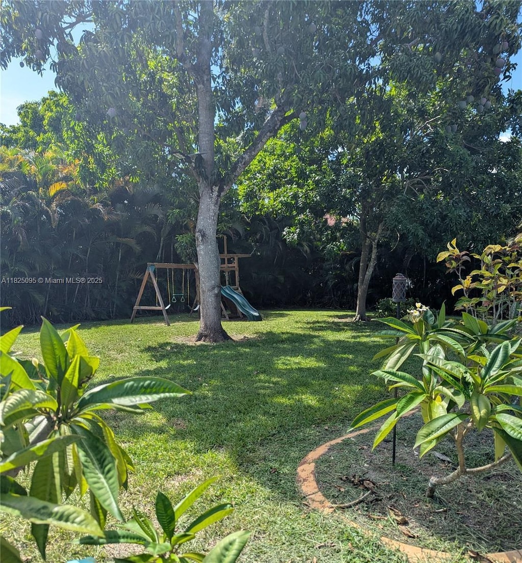 2171 NW 123rd Ave, Plantation, FL 33323 - view of grassy yard with a playground