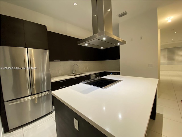 9181 NW 33rd St Unit 9181, Doral, FL 33172 - kitchen with freestanding refrigerator, island range hood, dark cabinetry, and light tile patterned floors