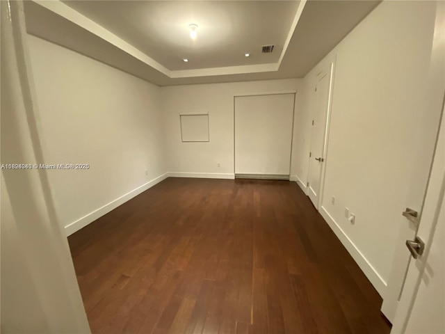 9181 NW 33rd St Unit 9181, Doral, FL 33172 - unfurnished room with a tray ceiling and dark wood-type flooring