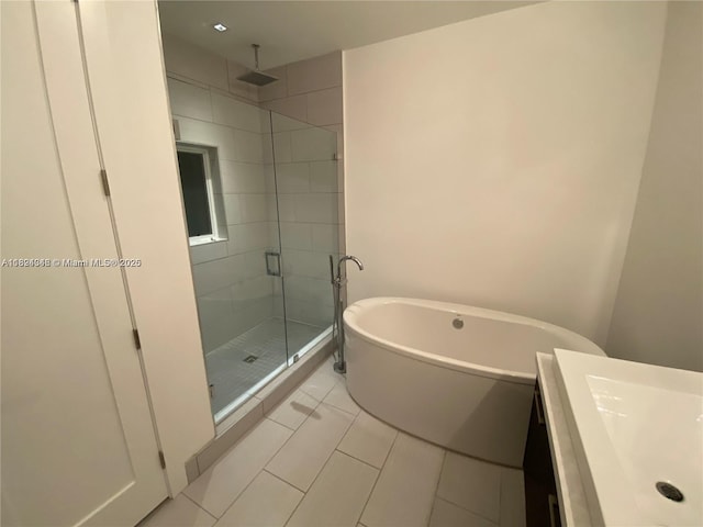9181 NW 33rd St Unit 9181, Doral, FL 33172 - bathroom featuring a stall shower, a soaking tub, vanity, and tile patterned flooring