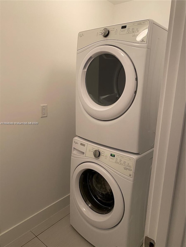 9181 NW 33rd St Unit 9181, Doral, FL 33172 - washroom featuring stacked washer / dryer and tile patterned flooring