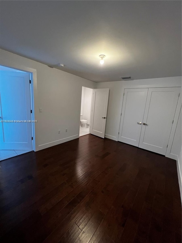 9181 NW 33rd St Unit 9181, Doral, FL 33172 - unfurnished bedroom with dark wood finished floors, ensuite bathroom, and a closet