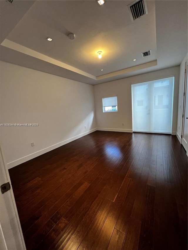 9181 NW 33rd St Unit 9181, Doral, FL 33172 - unfurnished room with a tray ceiling, dark wood-style flooring, recessed lighting, and a smoke detector