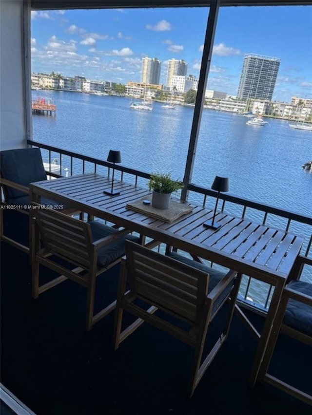 300 Golden Isles Dr Unit 311, Hallandale Beach, FL 33009 - balcony featuring a water view, a view of city, and outdoor dining space