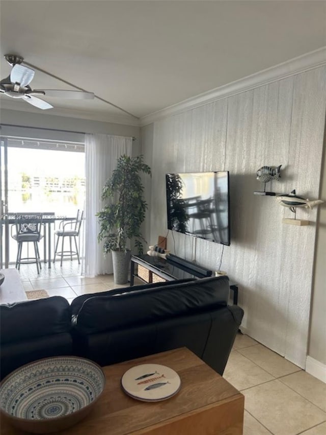 300 Golden Isles Dr Unit 311, Hallandale Beach, FL 33009 - living room featuring light tile patterned flooring, crown molding, ceiling fan, and wood walls