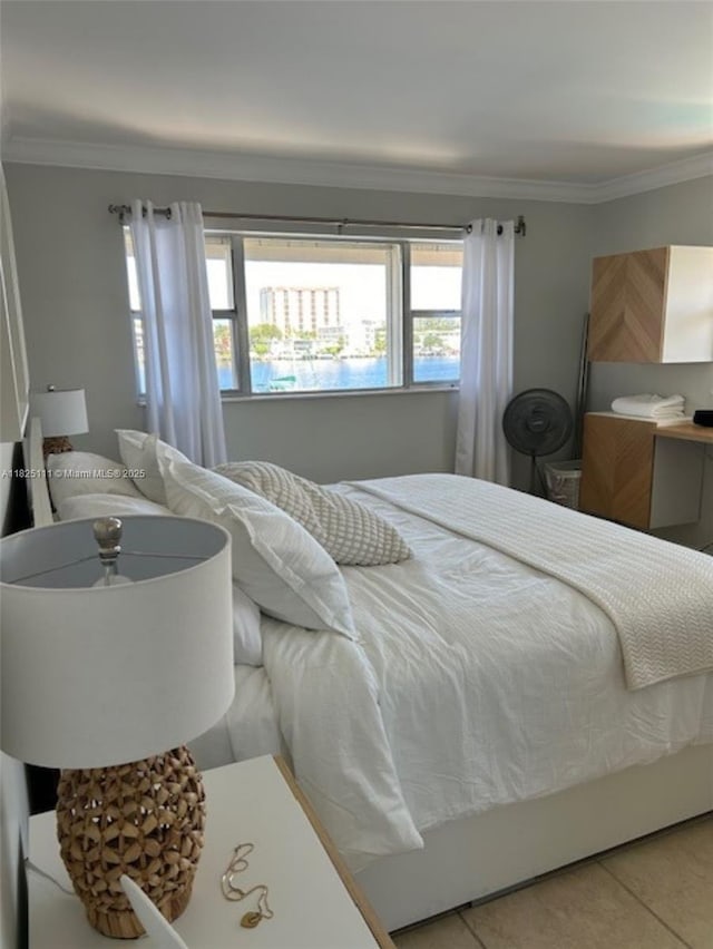 300 Golden Isles Dr Unit 311, Hallandale Beach, FL 33009 - bedroom featuring crown molding and light tile patterned flooring