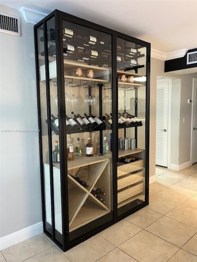 300 Golden Isles Dr Unit 311, Hallandale Beach, FL 33009 - wine cellar with ornamental molding and tile patterned flooring