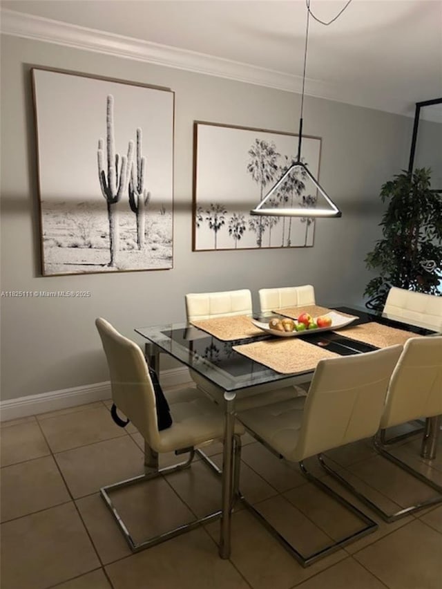 300 Golden Isles Dr Unit 311, Hallandale Beach, FL 33009 - tiled dining room featuring ornamental molding and baseboards