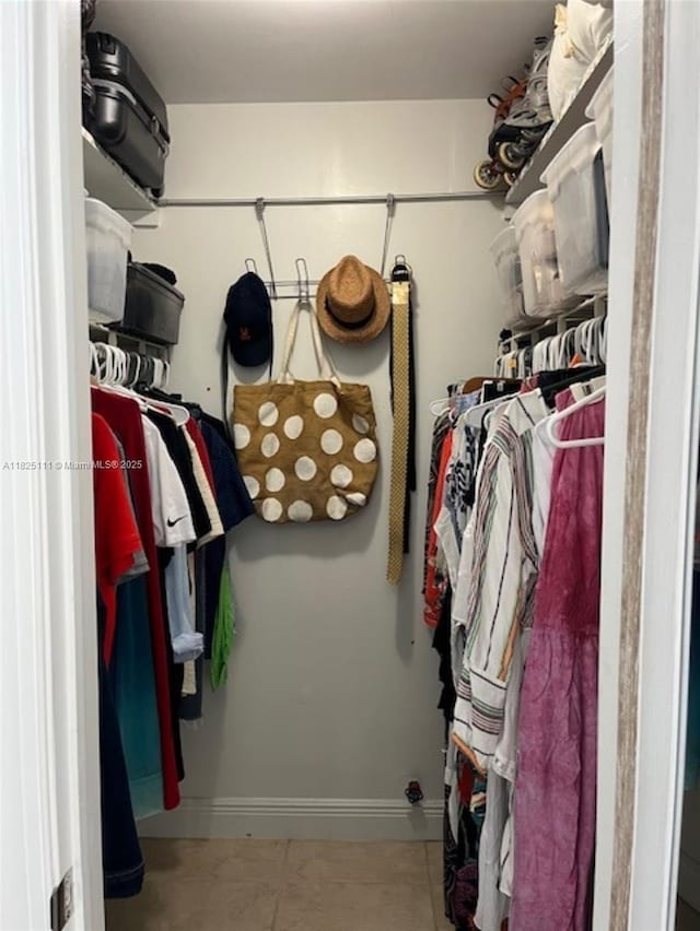 300 Golden Isles Dr Unit 311, Hallandale Beach, FL 33009 - walk in closet featuring tile patterned flooring