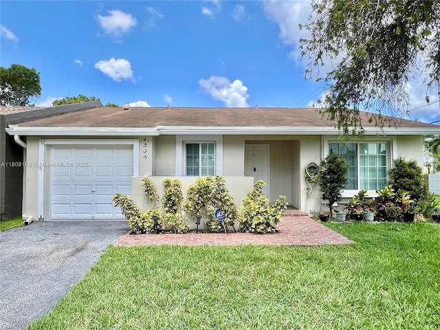 453 Lakewood Cir Unit A, Margate, FL 33063 - single story home with an attached garage, a front yard, asphalt driveway, stucco siding, and a shingled roof