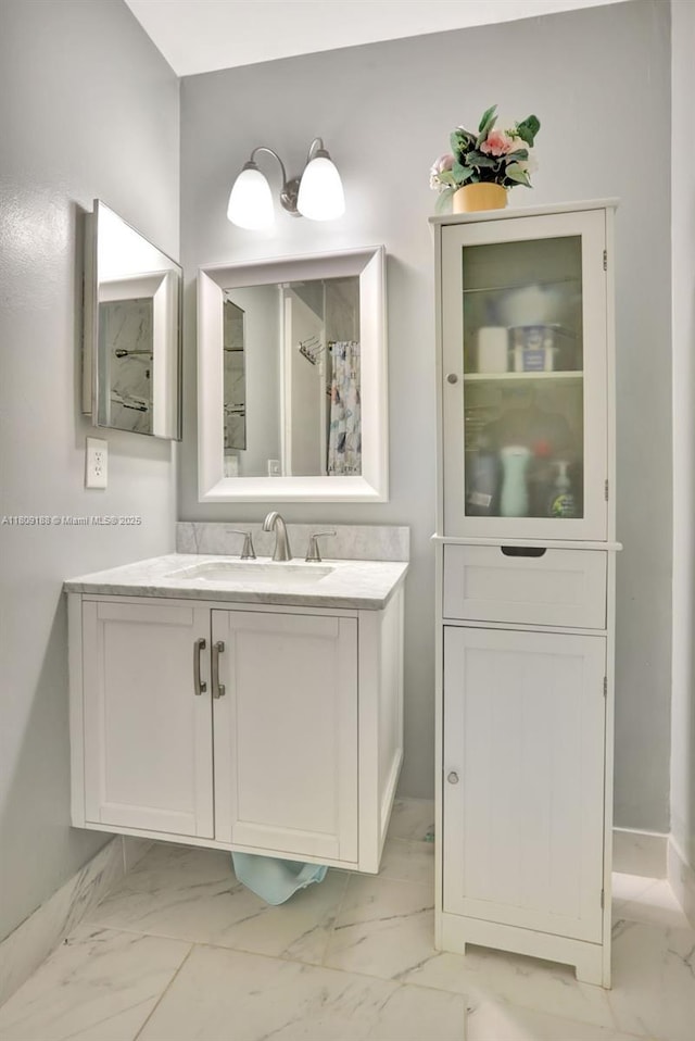 453 Lakewood Cir Unit A, Margate, FL 33063 - bathroom featuring marble look tile flooring and vanity